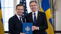 US Secretary of State Antony Blinken receives the NATO ratification documents from Swedish Prime Minister Ulf Kristersson during a ceremony at the US State Department, as Sweden formally joins the North Atlantic alliance, in Washington, DC, on March 7, 2024. Kristersson hailed his country's entry into NATO as a "victory for freedom," as it turned the page on two centuries of non-alignment following Russia's invasion of Ukraine. The accession "is a victory for freedom today. Sweden has made a free, democratic, sovereign and united choice to join NATO," he said at the ceremony.