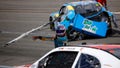 Joey Gase, driver of the #35 NCPC Race Against Crime Chevrolet, throws his wrecked rear bumper cover at Dawson Cram, driver of the #4 TeamJDMotorsports.com Chevrolet,  after an on-track incident during the NASCAR Xfinity Series ToyotaCare 250 at Richmond Raceway on March 30, 2024 in Richmond, Virginia.