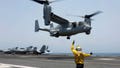 Aviation Boatswain's Mate 2nd Class Nicholas Hawkins, signals an MV-22 Osprey to land on the flight deck of the USS Abraham Lincoln in the Arabian Sea on May 17, 2019. The military has greenlighted its Osprey to return to flight, three months after a part failure led to the deaths of eight service members in a crash in Japan in November. Naval Air Systems Command announced it on Friday.