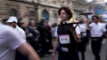 Waiters carry trays with a cup of coffee, a croissant and a glass of water as they take part in a waiter's run through the streets of Paris, Sunday, March 24, 2024.