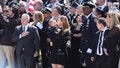 Widow Stephanie Diller and son Ryan are seen at the  funeral service for New York City Police Department Officer Jonathan Diller was held at Saint Rose of Lima Roman Catholic Church in Massapequa Park, N.Y., on Saturday, March 30, 2024.