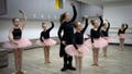 A ballet coach teaches girls in a ballet studio in a bomb shelter in Kharkiv, Ukraine, Monday, March 18, 2024. In northeast Ukraine, a dance studio that doubles as a bomb shelter is an escape from the horrors of war for about 20 young girls. The Princess Ballet Studio in Kharkiv is a spartan, windowless room, but practicing underground means they can dance through the almost hourly air raid alerts.