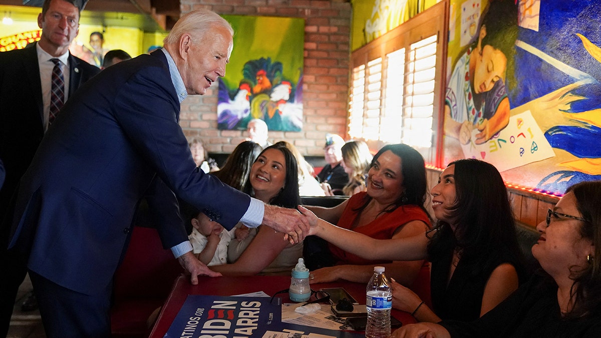Biden shaking hands with supporters