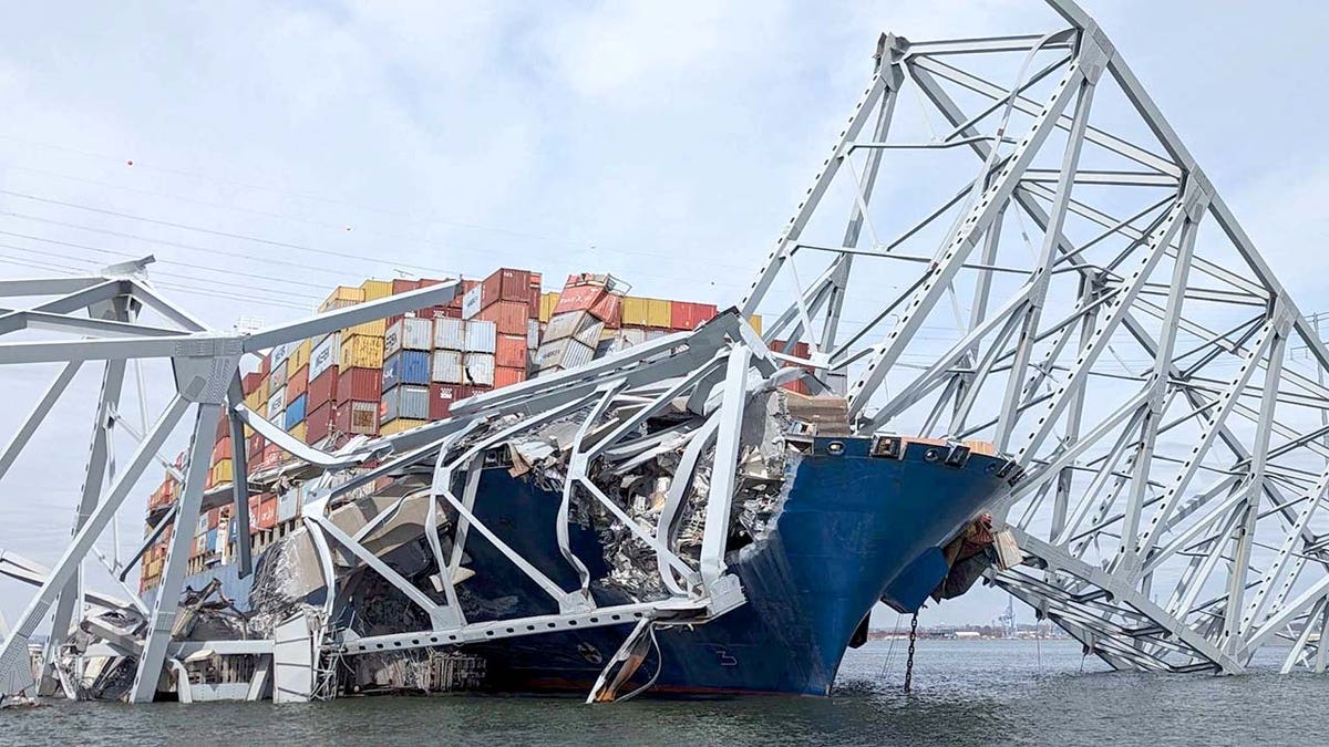 Part of a span of the collapsed Francis Scott Key Bridge is suspended on the container ship Dali in Baltimore, Maryland, U.S., March 26, 2024. U.S