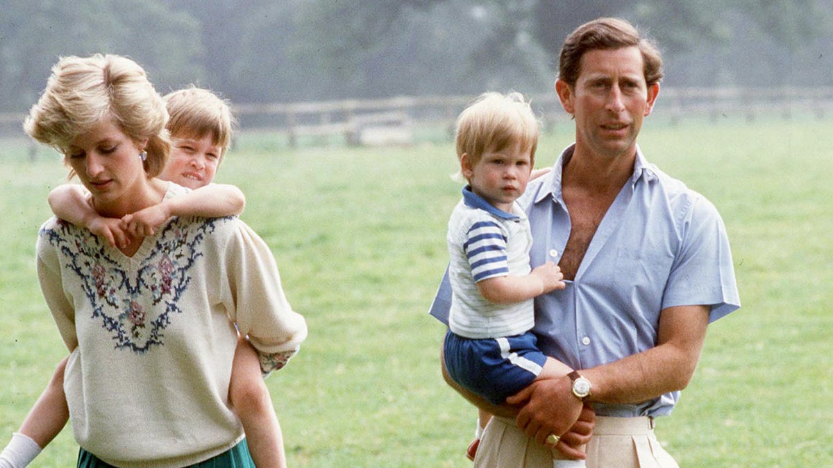 Princess Diana and Prince Charles carrying their sons