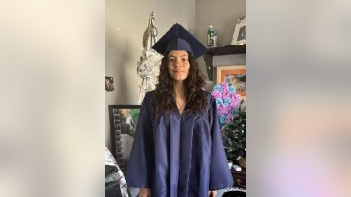 Kaitlin Hernandez wearing a graduation cap and gown