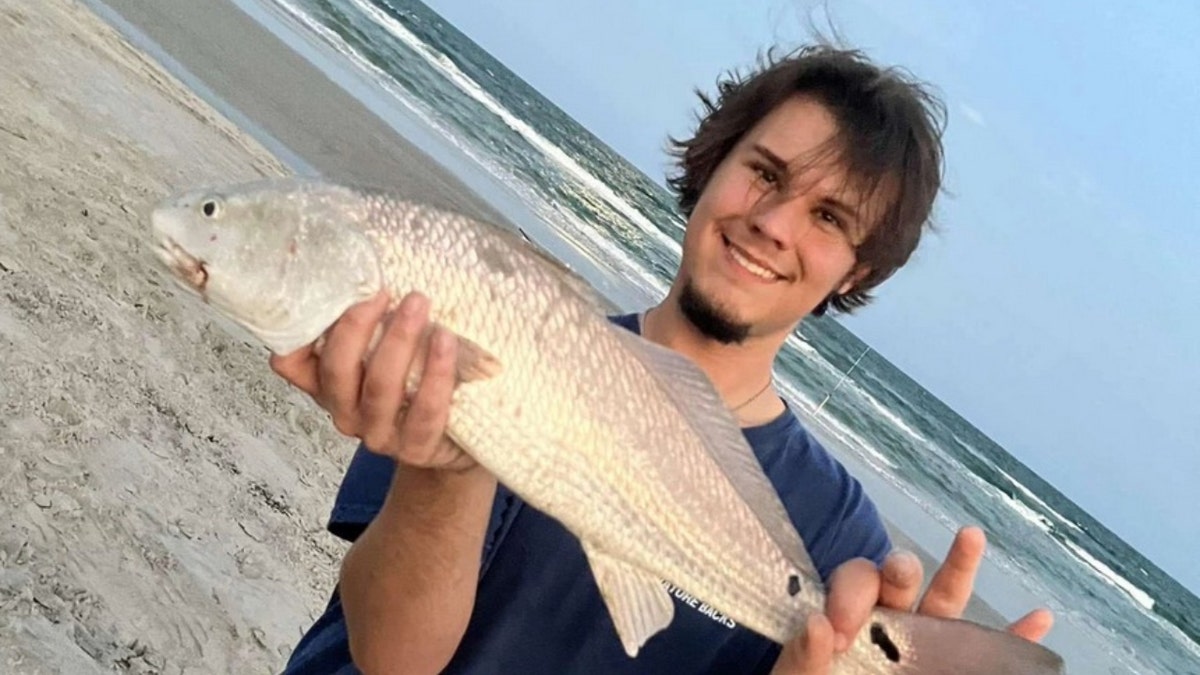 Caleb Harris holding a fish