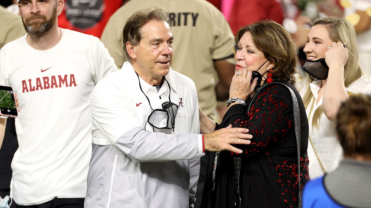 Nick Saban with wife, Terry, on field