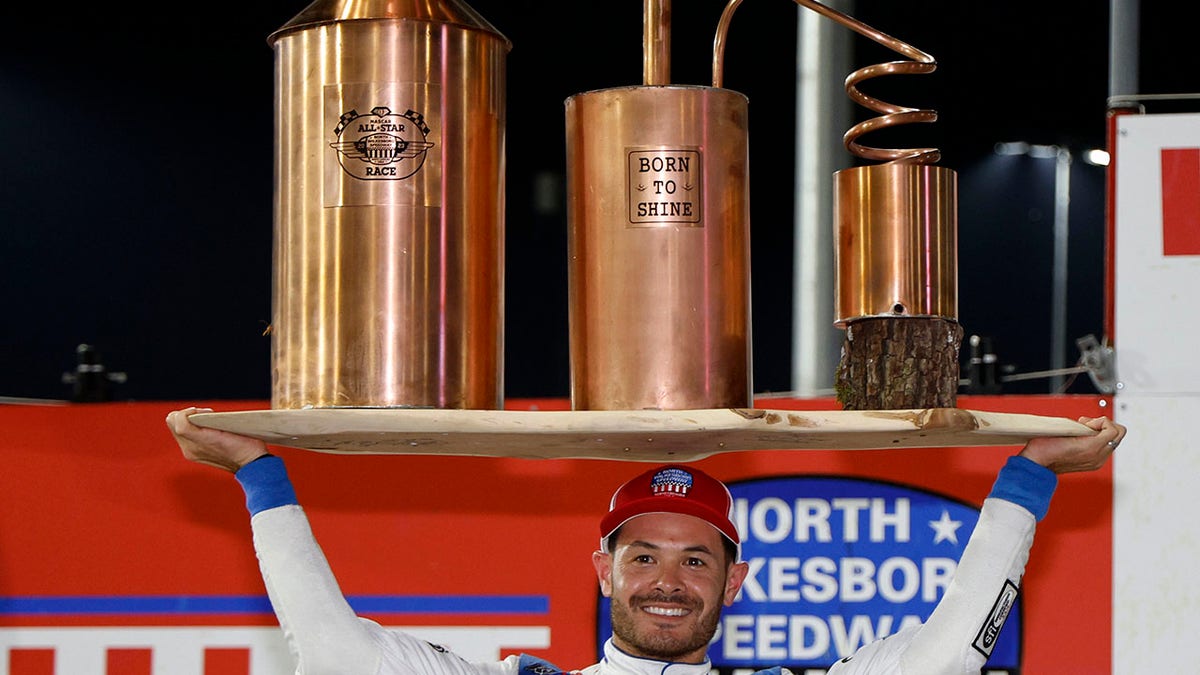 Kyle Larson holds the trophy