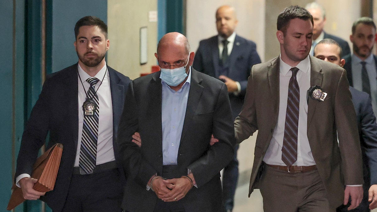 Allen Weisselberg, center, is escorted to Manhattan criminal court, Monday, March 4, 2024, in New York.