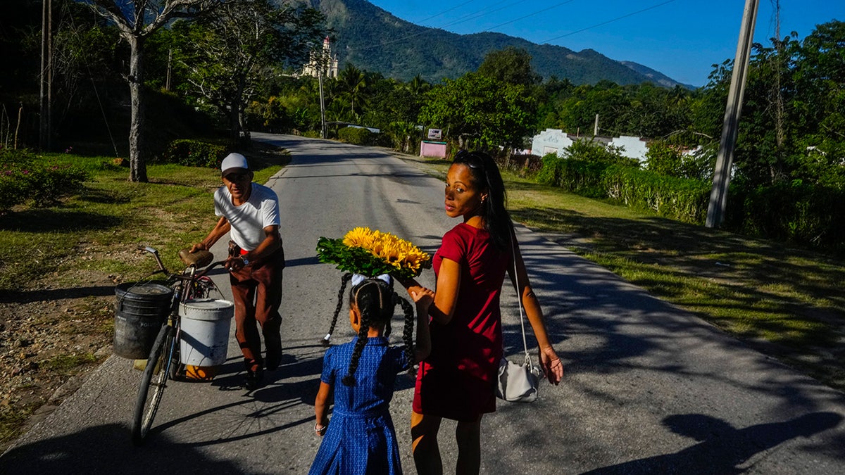 Mother and daughter walking with flowers