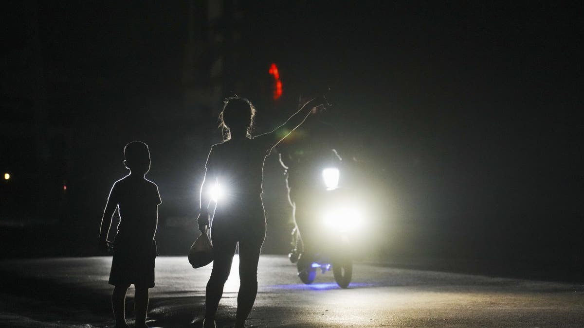 woman and boy in cuba hitchhike