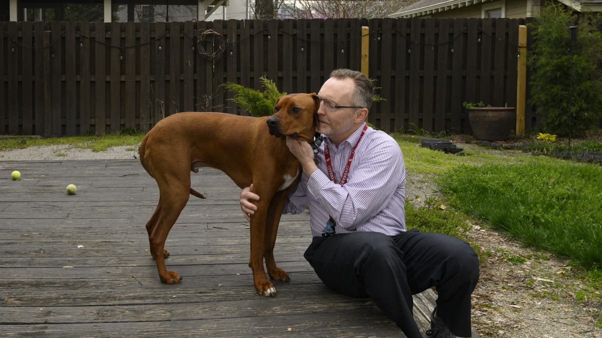 Covenant school chaplain and adopted dog