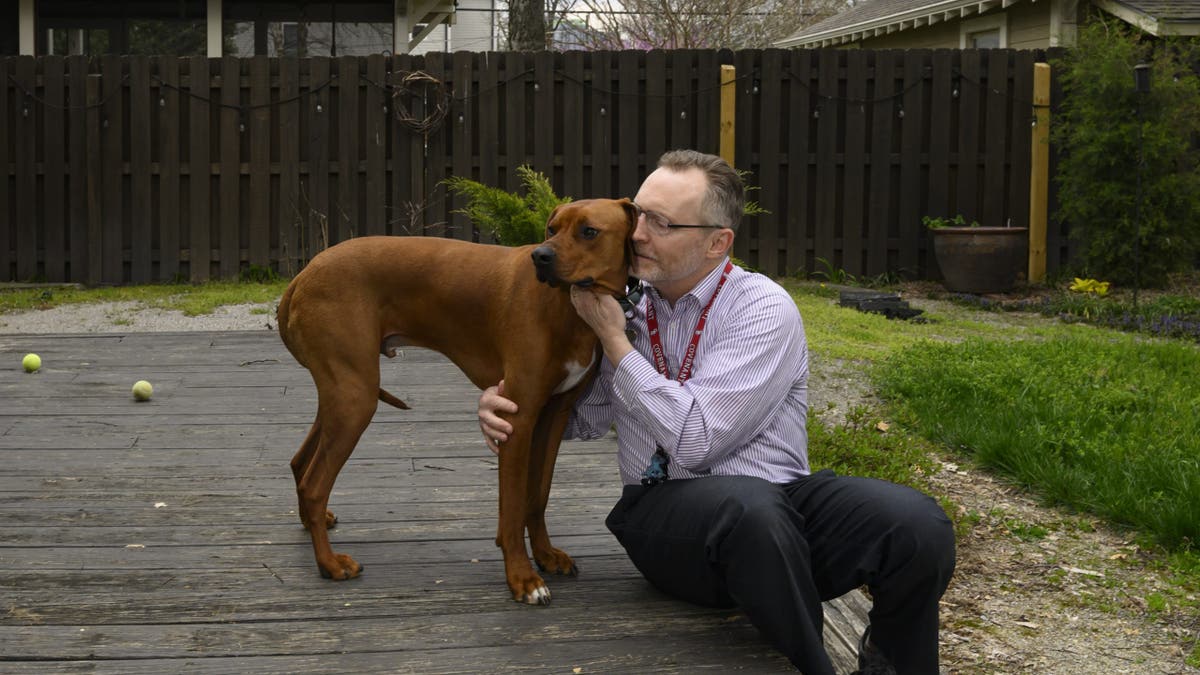 Covenant school chaplain and adopted dog