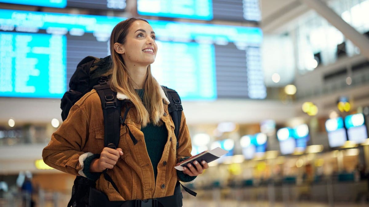 A woman walks through an airport