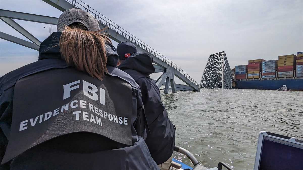 FBI Evidence Response Team members work at the site of the Francis Scott Key Bridge collapse
