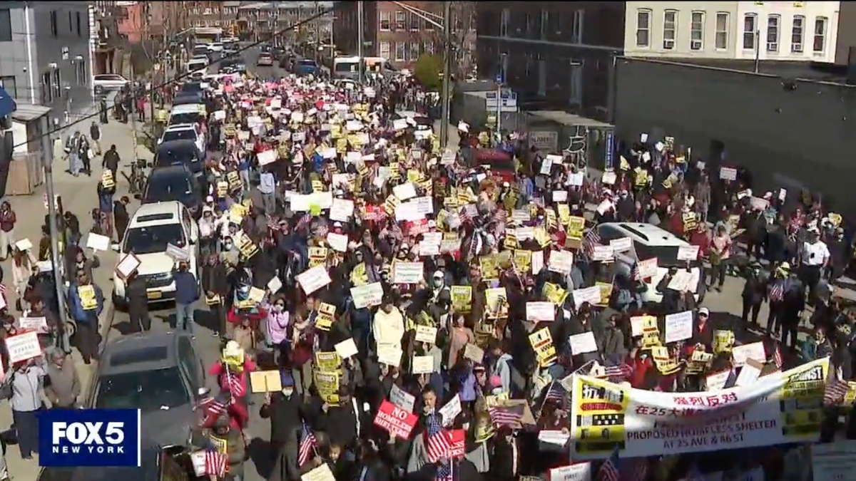 Streetshot of crowd marching against Bensonhurst shelter