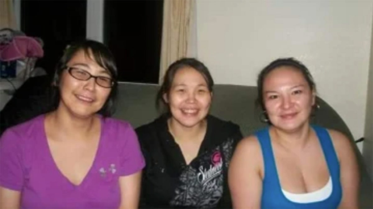 Florence Okpealuk with two women as they sit down and smile together