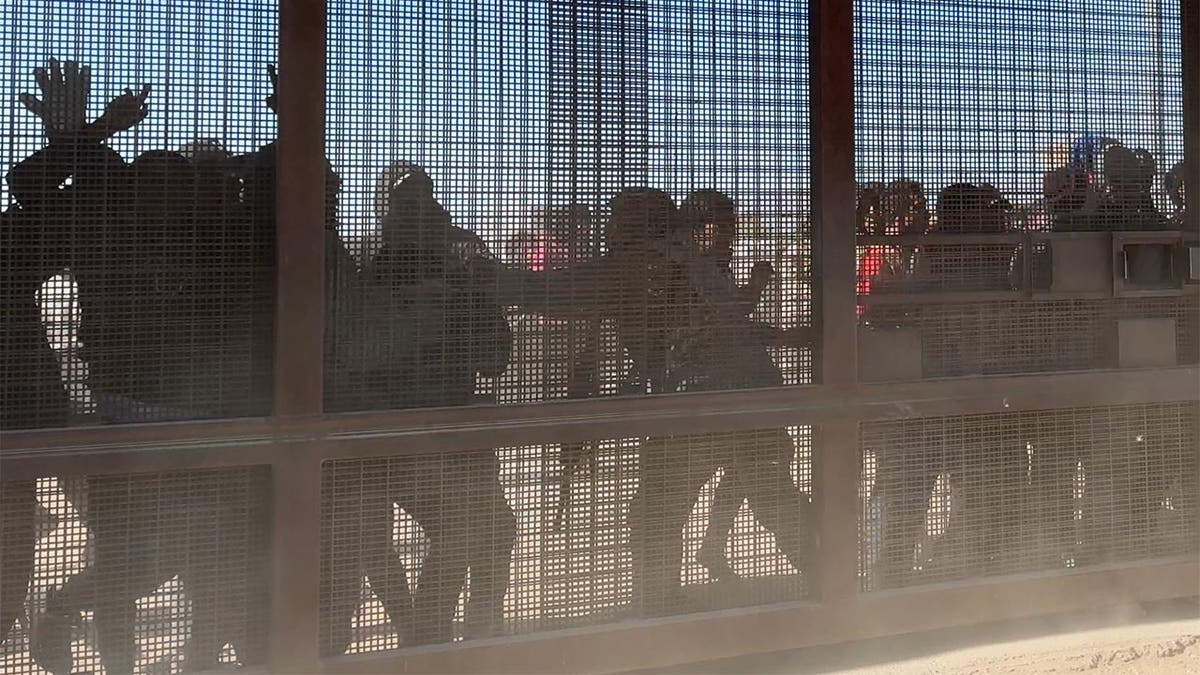 Migrants storm border gate in El Paso