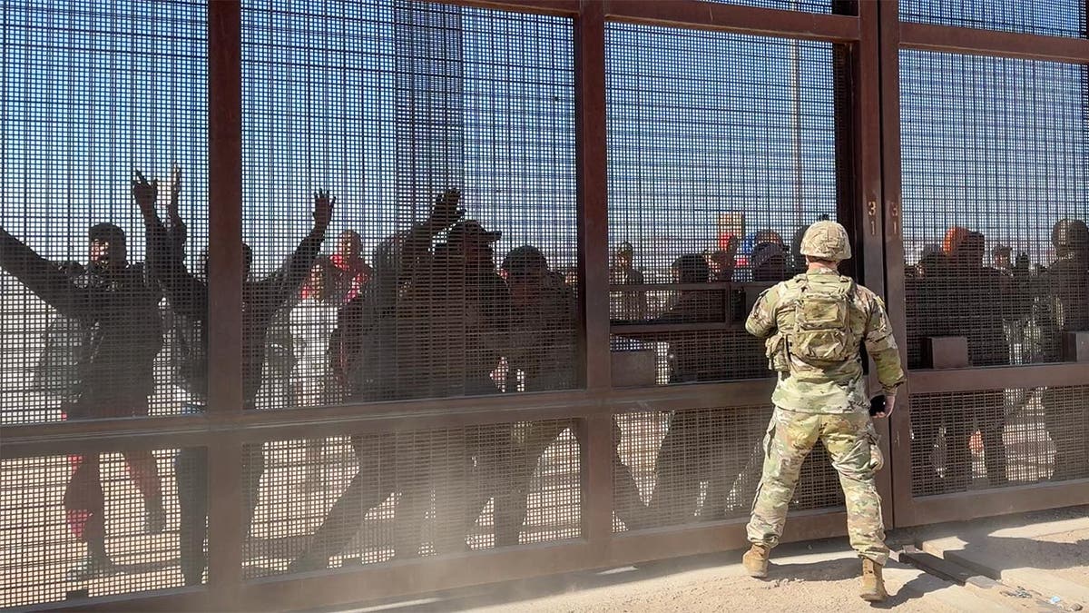 Migrants storm the border gate in El Paso
