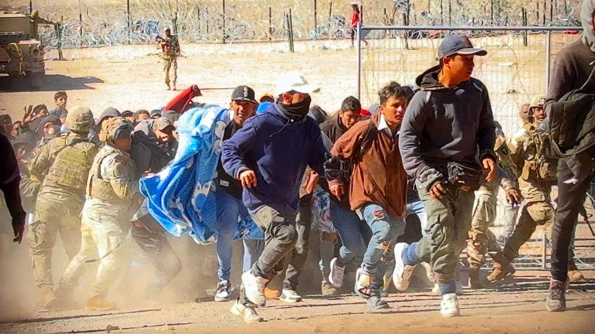 Migrants storm the gate at an El Paso border crossing