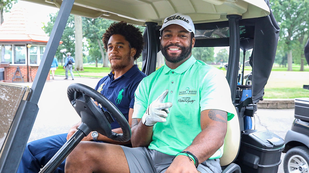 Braylon Edwards poses in golf cart
