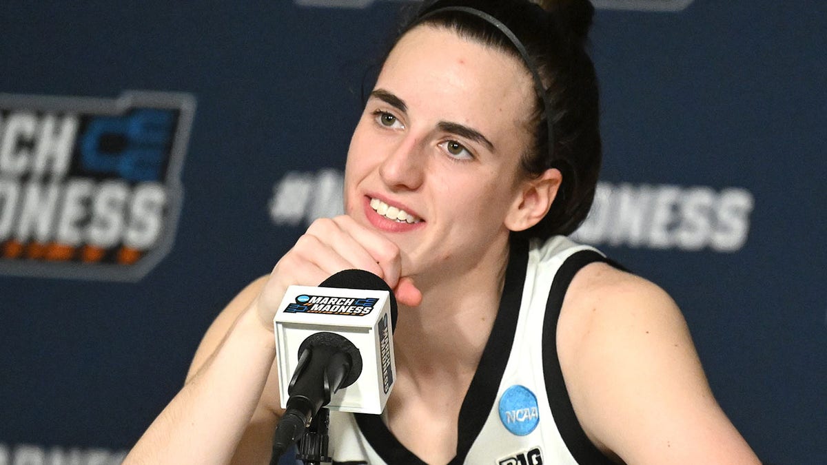 Caitlin Clark listens to reporters