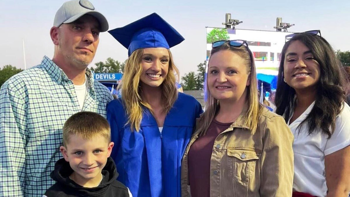 Cammy Vaughan is shown at her high school graduation with her father, stepmother, sister and brother.