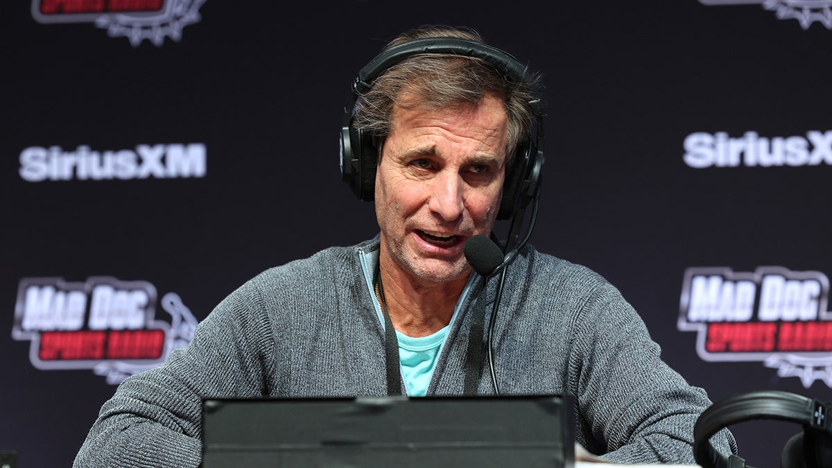 Chris "Mad Dog" Russo talks into microphone