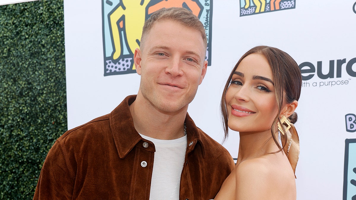 Christian McCaffrey and Olivia Culpo pose for picture