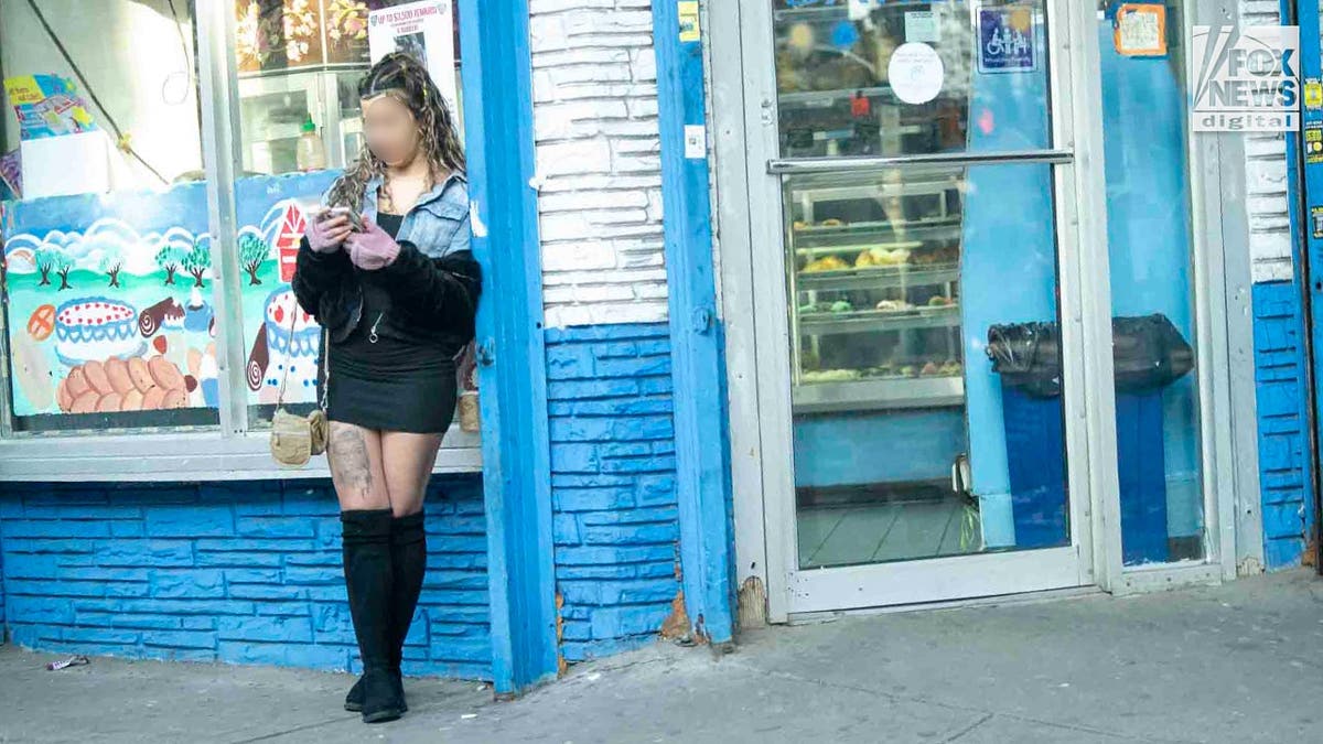 A sex worker standing on a street in Queens, New York.