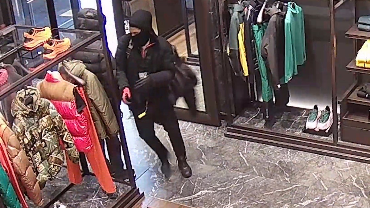 Man stealing Moncler coats
