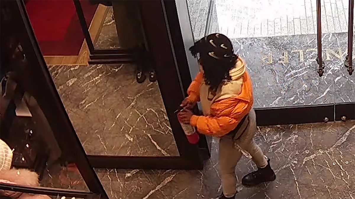DC Moncler theft wearing orange jacket