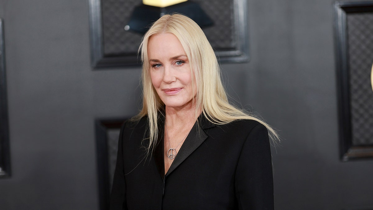 Daryl Hannah in a black suit looks stoic on the Grammy's carpet