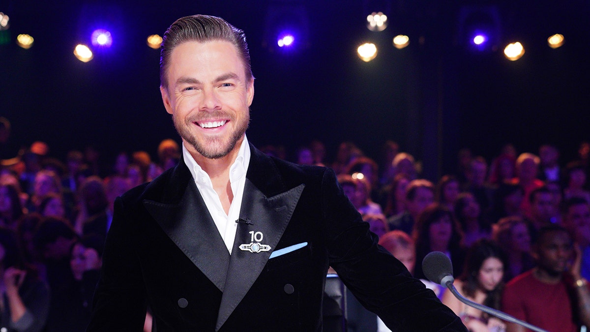 Derek Hough smiling on the set of Dancing with the Stars