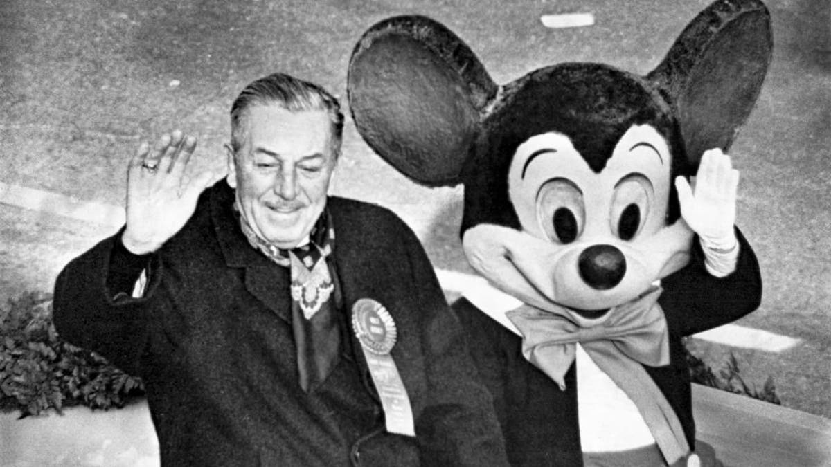 Walt Disney with Mickey Mouse in black and white photo