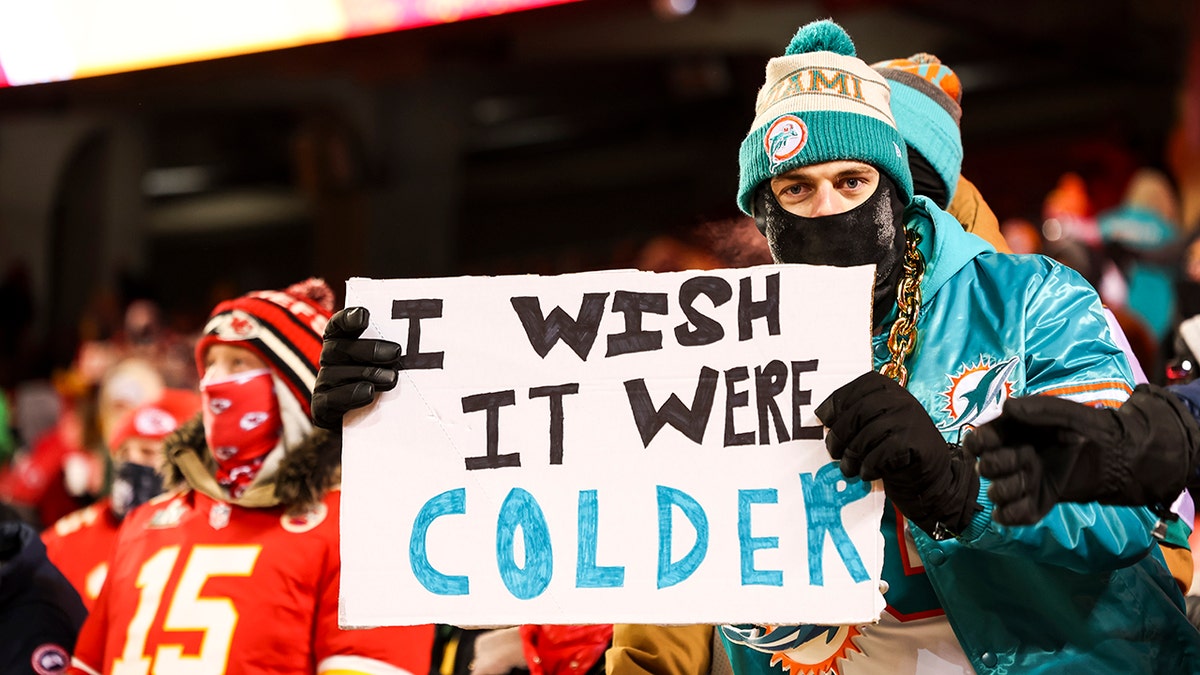 Dolphins fan holds sign reading "I wish it were colder"