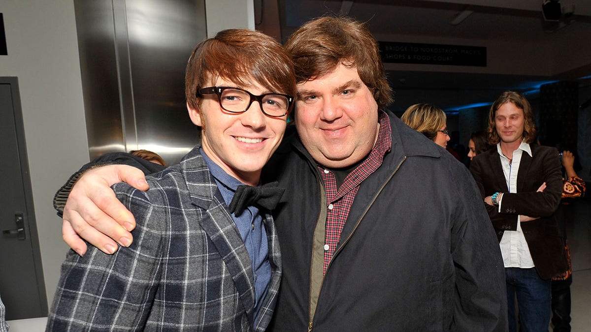 Actor Drake Bell wears plaid jacket with Nickelodeon producer Dan Schneider