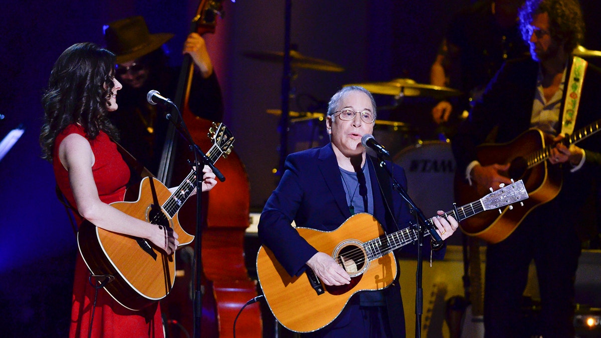 Edie Brickell and Paul Simon performing on stage together