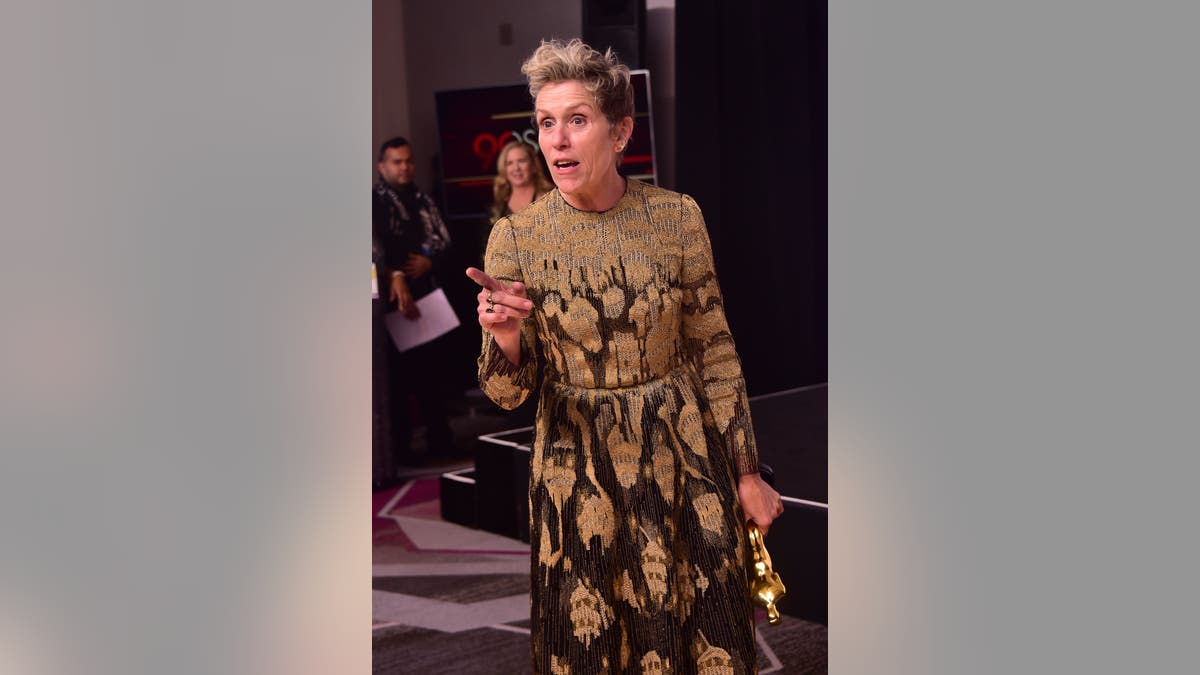 Frances McDormand in the press room holding her Oscar