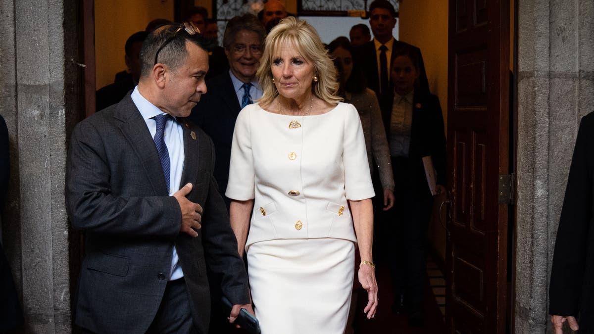 Anthony Bernal left, walking with first lady Jill Biden