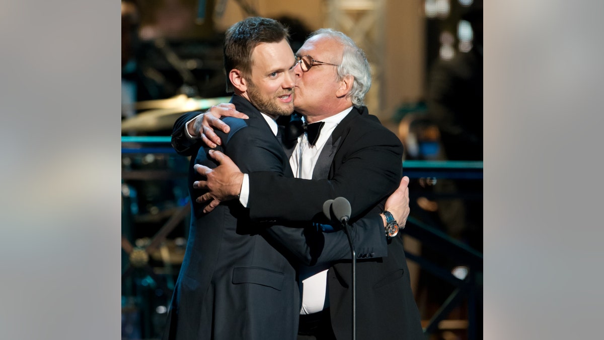 Joel McHale and Chevy Chase onstage