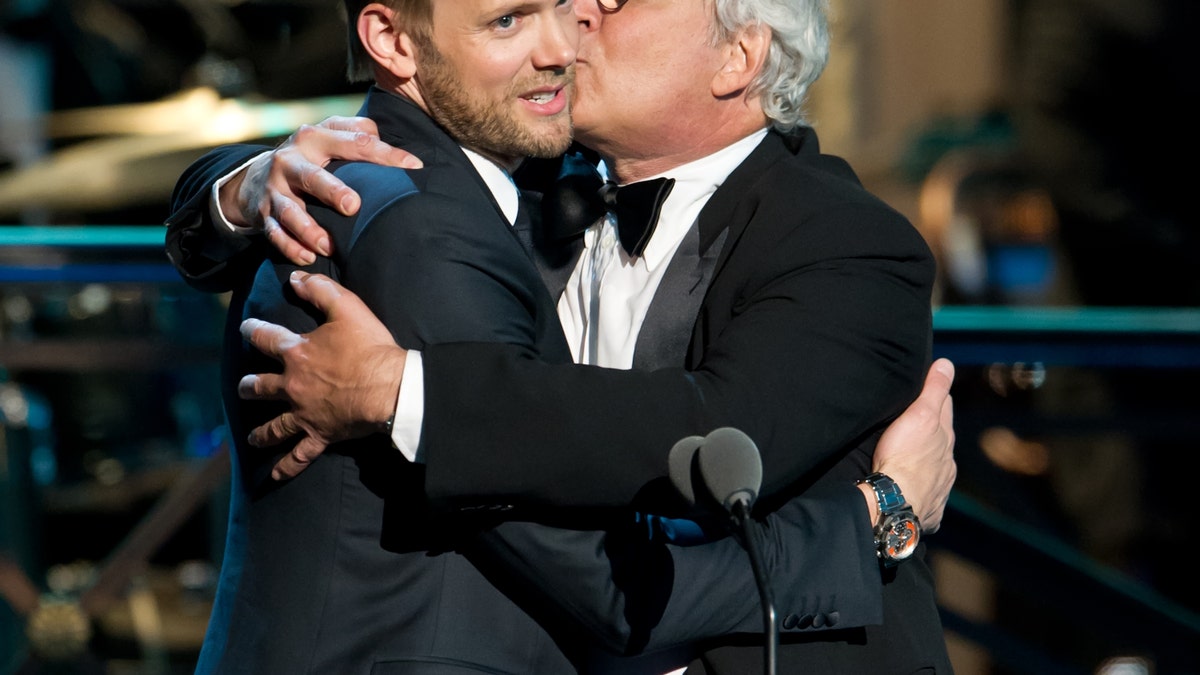 Joel McHale and Chevy Chase onstage