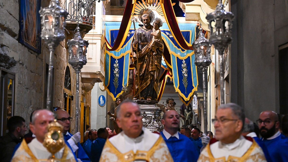 Statue of St. Joseph carried by clergy connected St. Joseph's Day