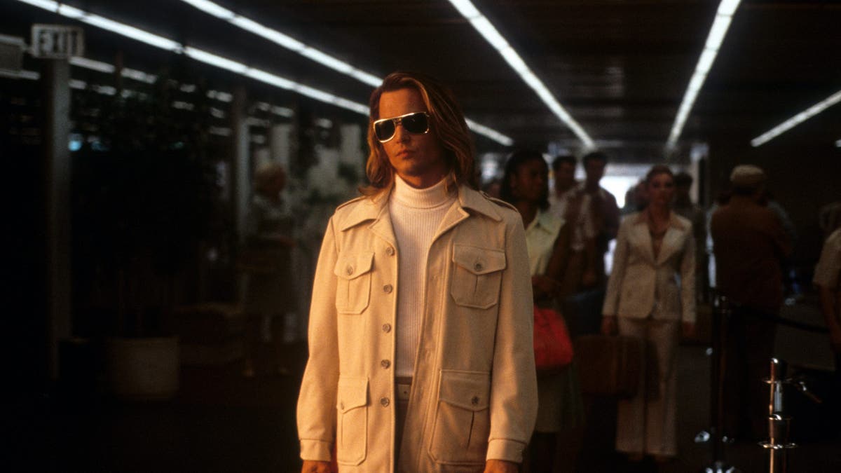 johnny depp at the airport in a scene from blow