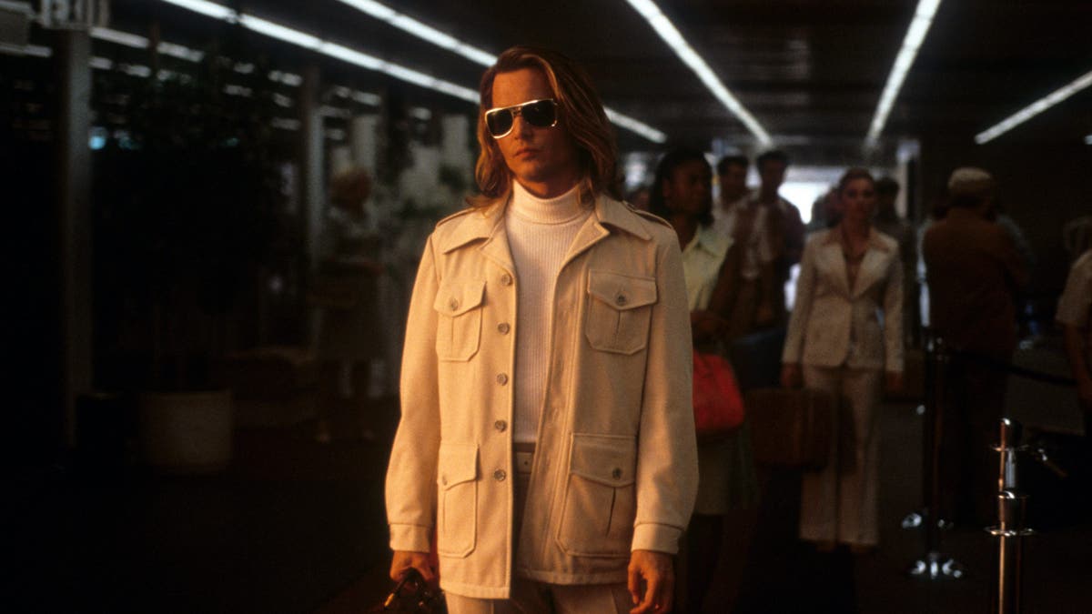 johnny depp at the airport in a scene from blow