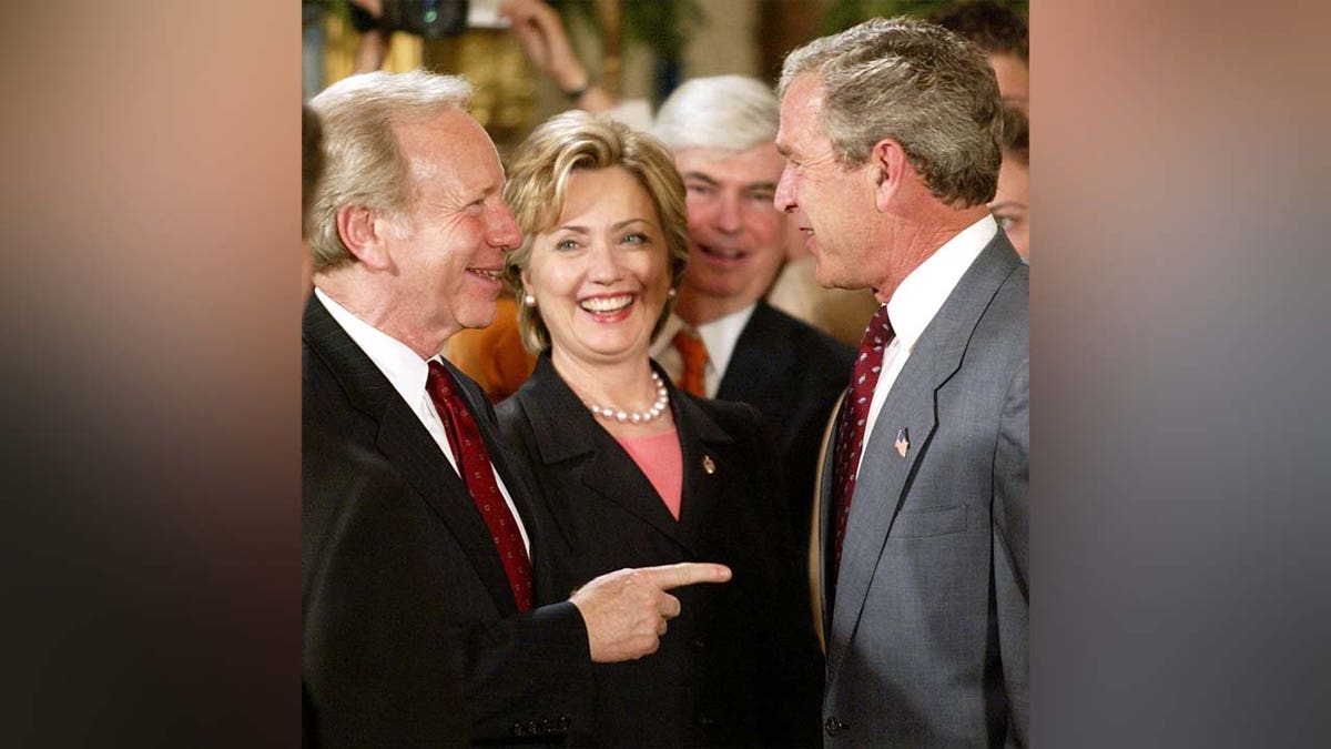 President George W. Bush spoke with Joe Lieberman and Hillary Clinton after an event in the East Room of the White House on June 17, 2003.