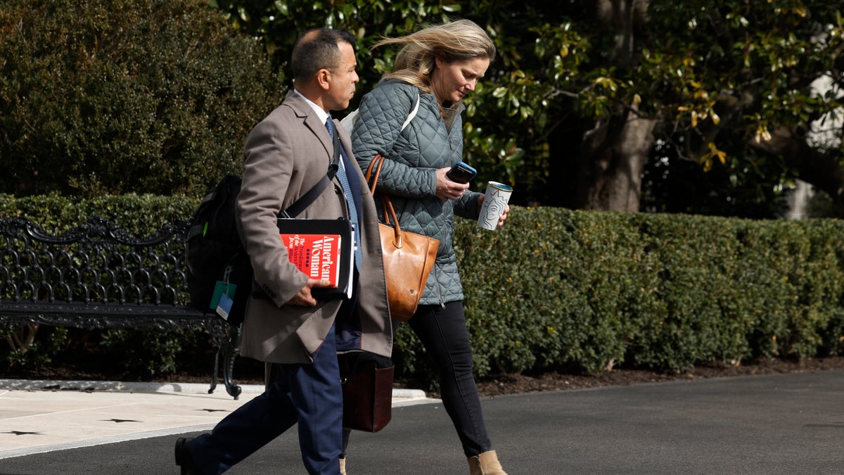 Anthony Bernal, left, walking with a White House aide