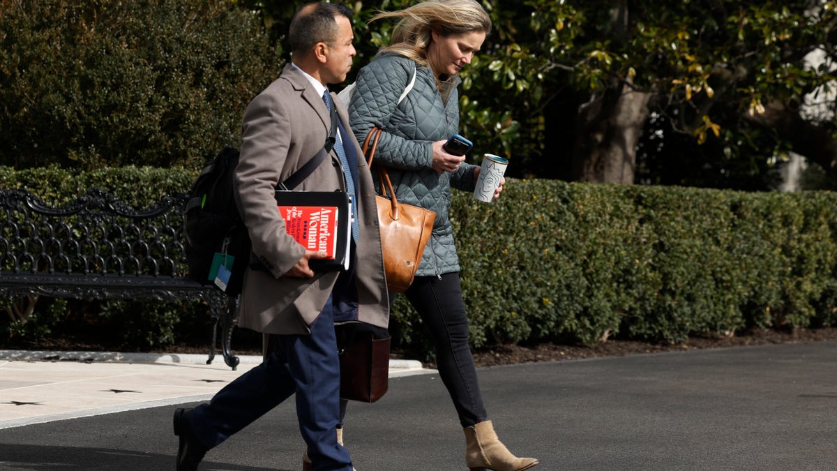 Anthony Bernal, left, walking with a White House aide