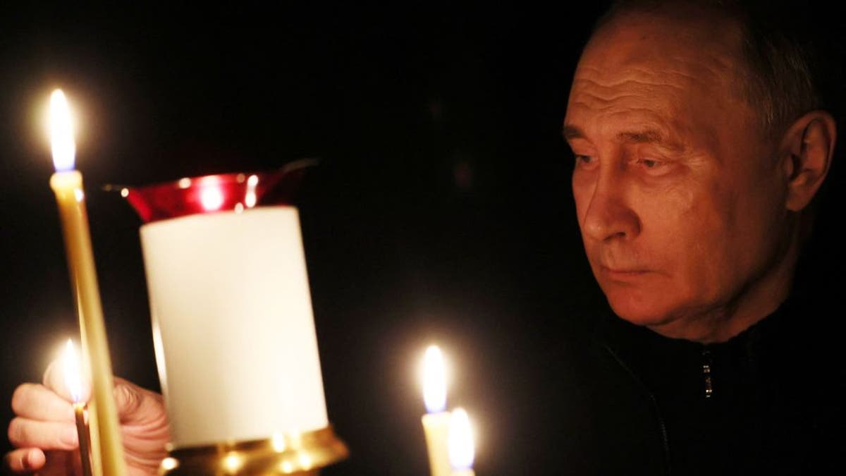 Putin at church service for those killed in terror attack.